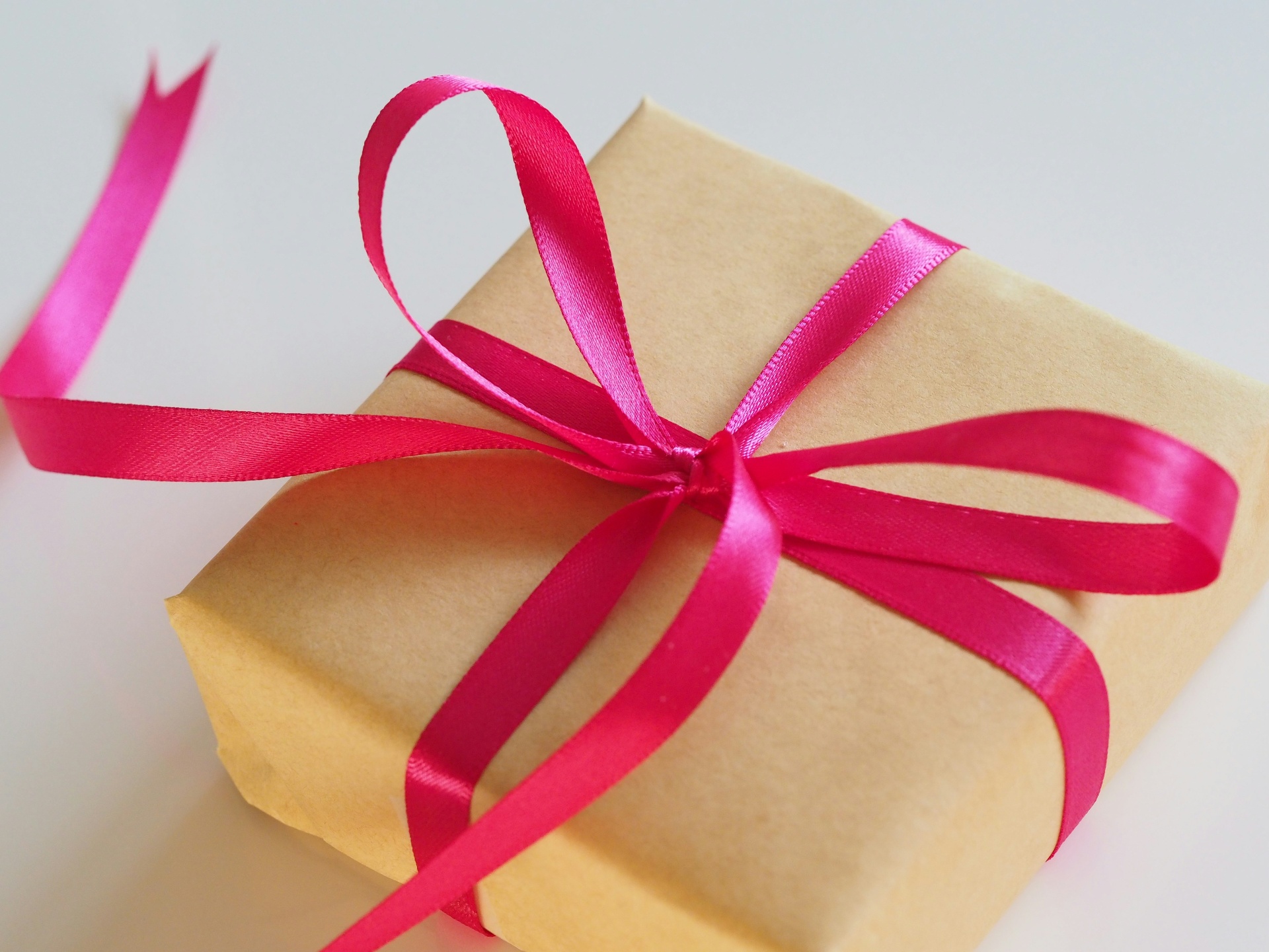 Beautifully wrapped gift with pink ribbon